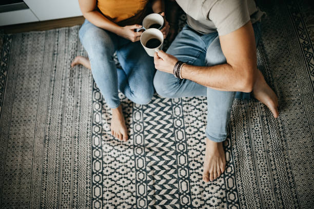 Couple drinking coffee sitting on floor | Warnike Carpet & Tile