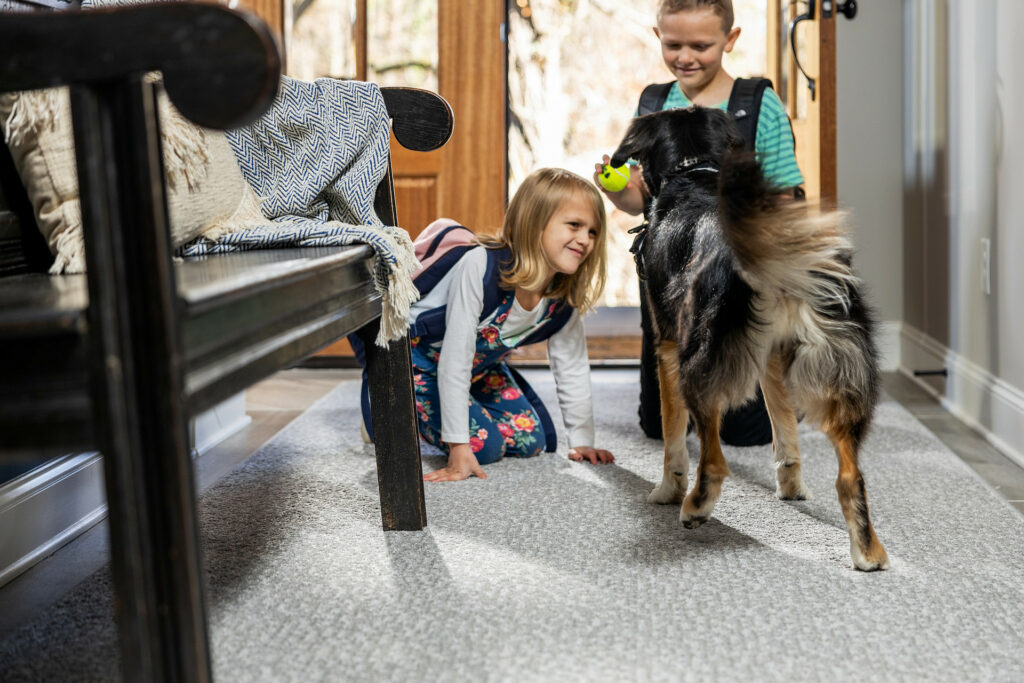 Kids playing with dog on carpet floors | Warnike Carpet & Tile
